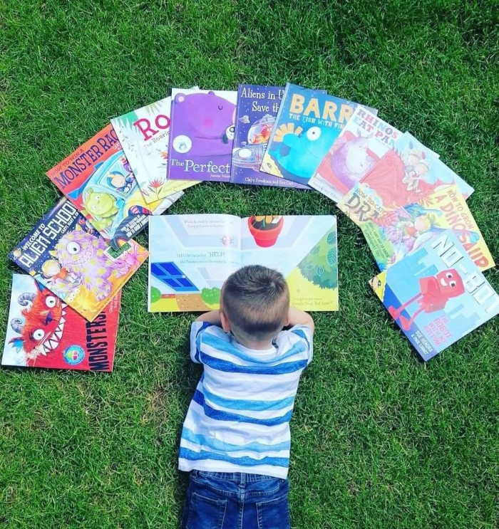 Child with books fanned out in front of them