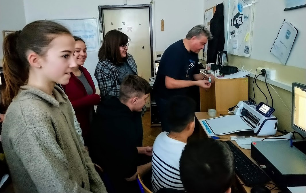 Pupils working together on project work using a 3D printer